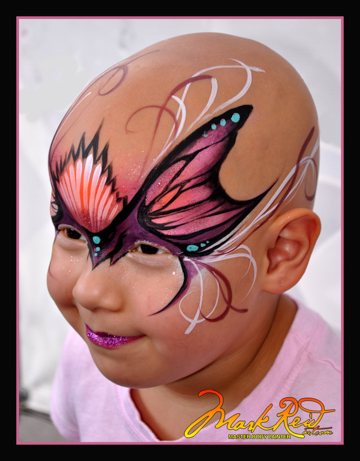 small child in a very beautiful and detailed face painting with a pink butterfly theme